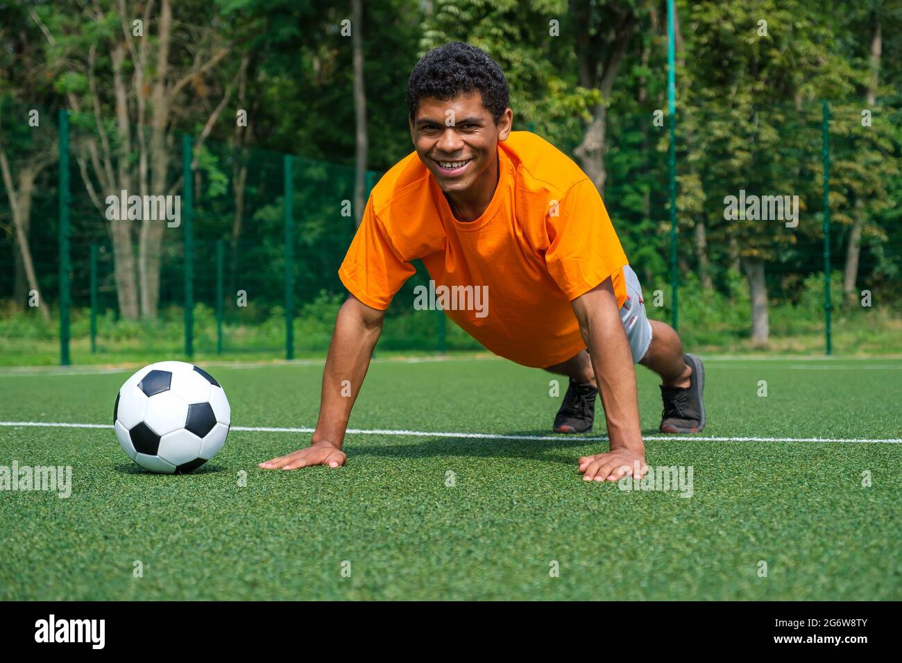 Brazilian footballer warms up on training on the sport ground in summer Stock Photo