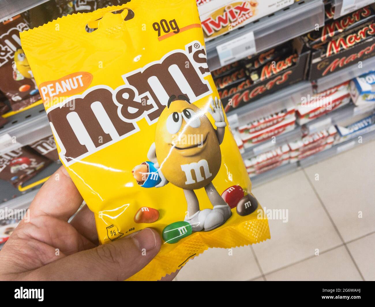 Picture of a box of M&M's with their iconic logo for sale in Belgrade. M&M's are multi-colored button-shaped chocolates, each of which has the letter Stock Photo