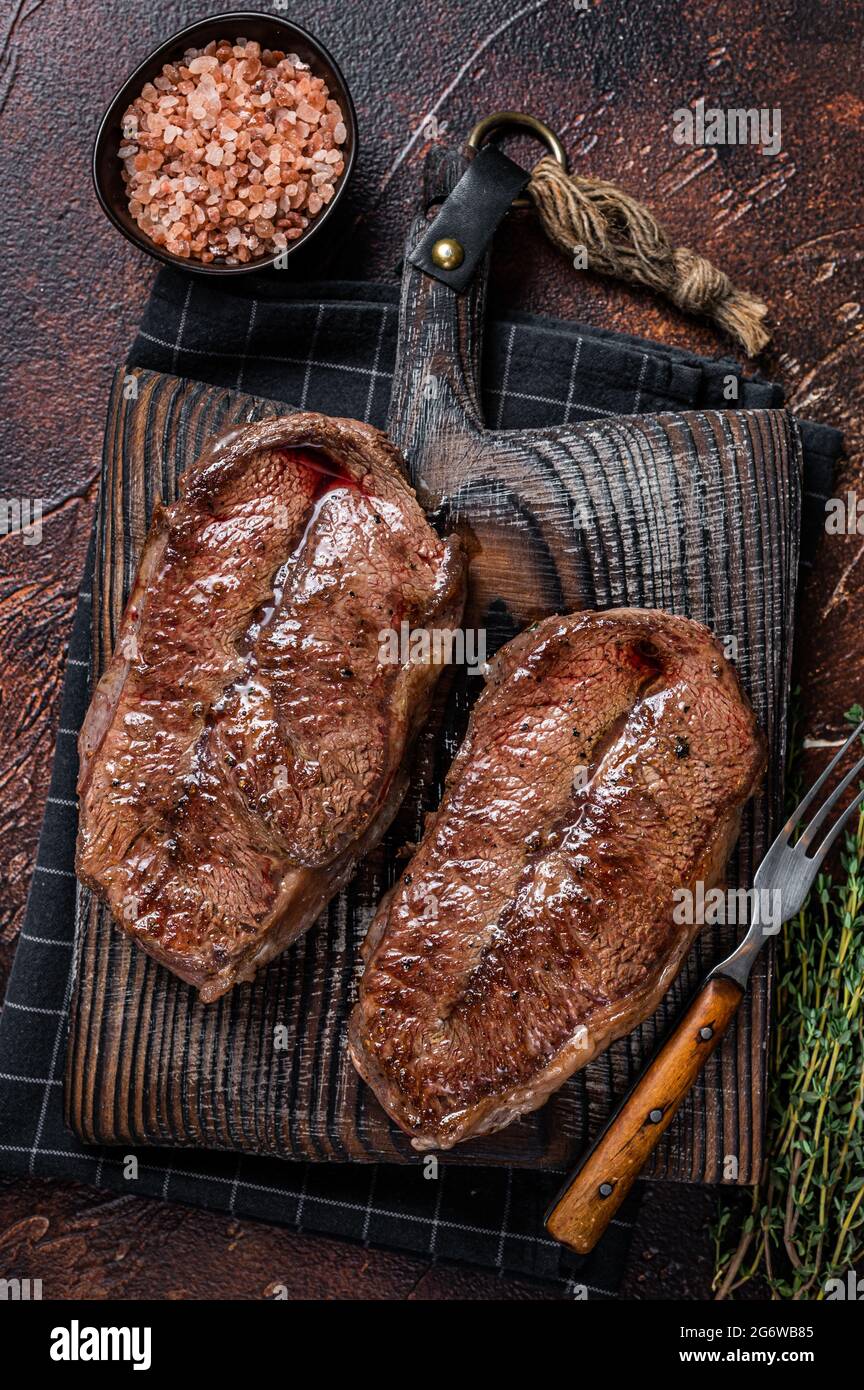 BBQ roasted Shoulder Top Blade cut or Australia wagyu oyster blade beef steak. Dark background
