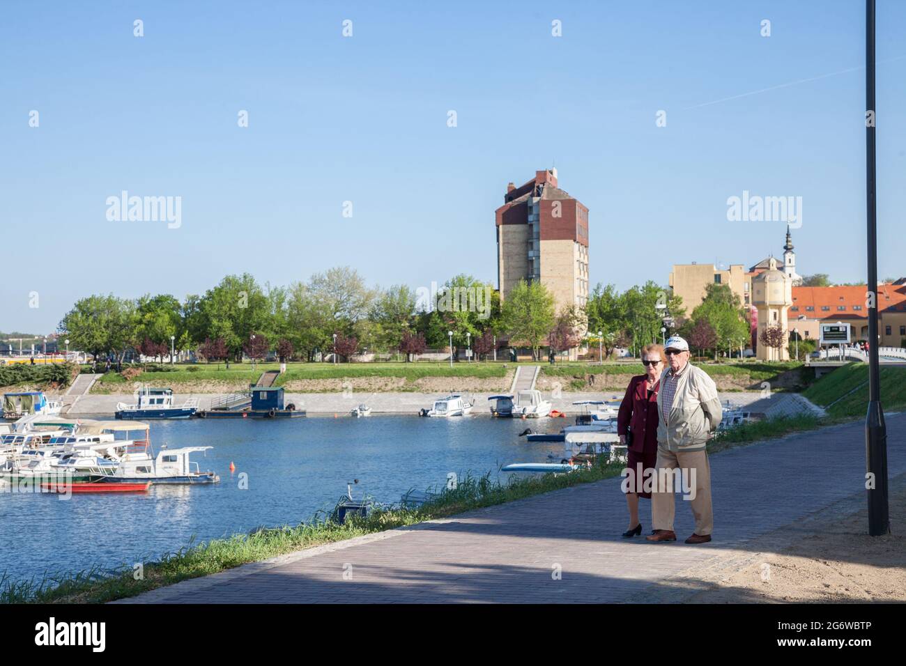 Picture of two elder persons walking by the riverside of Vukovar, Croatia. Vukovar is a city in eastern Croatia. It contains Croatia's largest river p Stock Photo