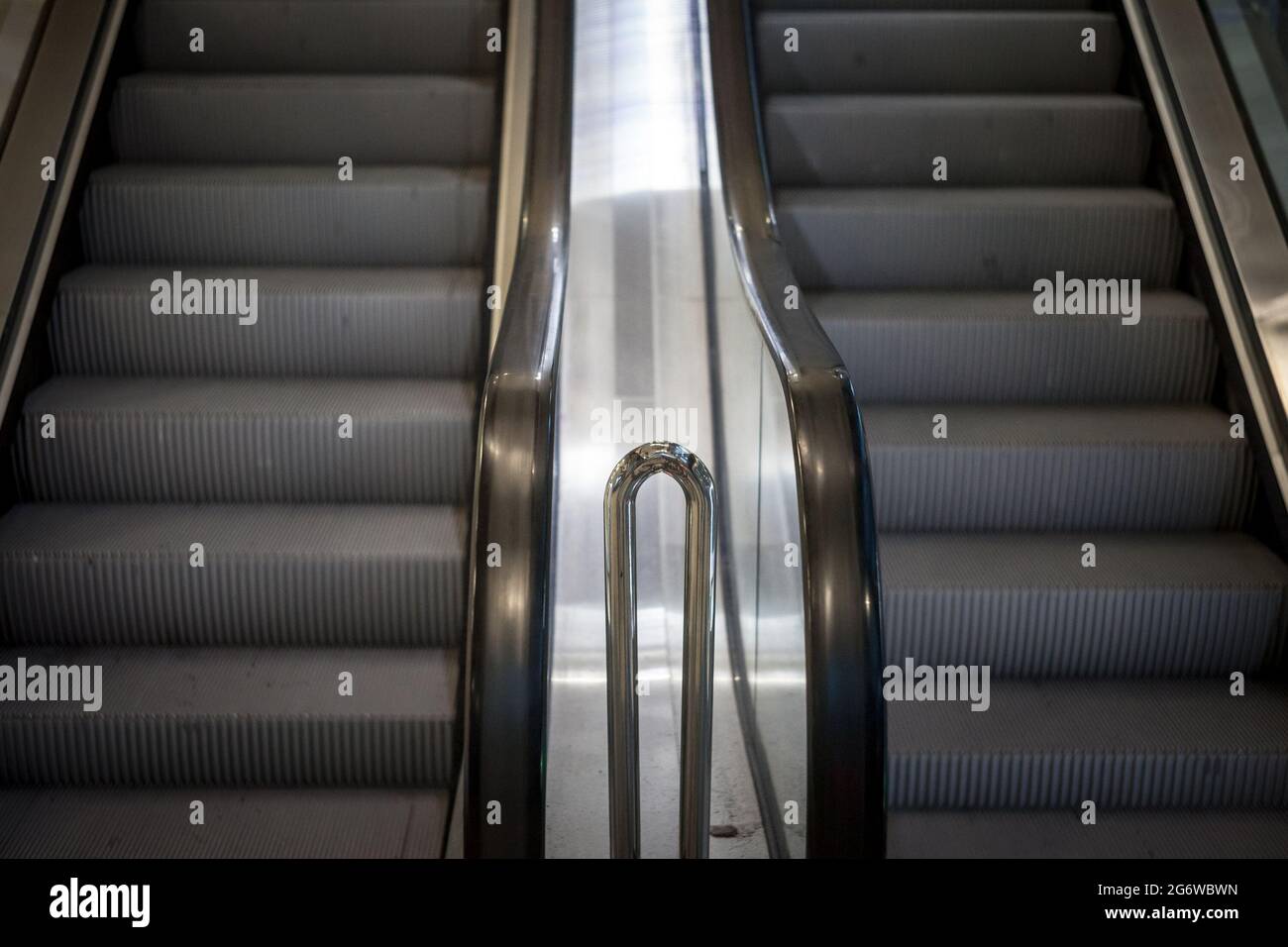 Picture of mecanical stairs, or escalators, in movementm without people, in a train station connecting the underground corridor and platforms Stock Photo