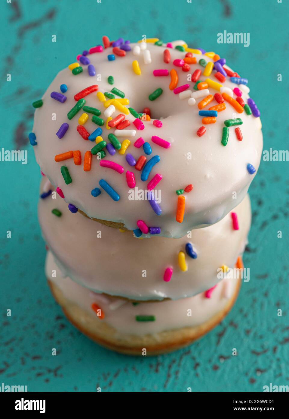 Cake Donut with White Frosting and Multicolored Sprinkles Stock Photo