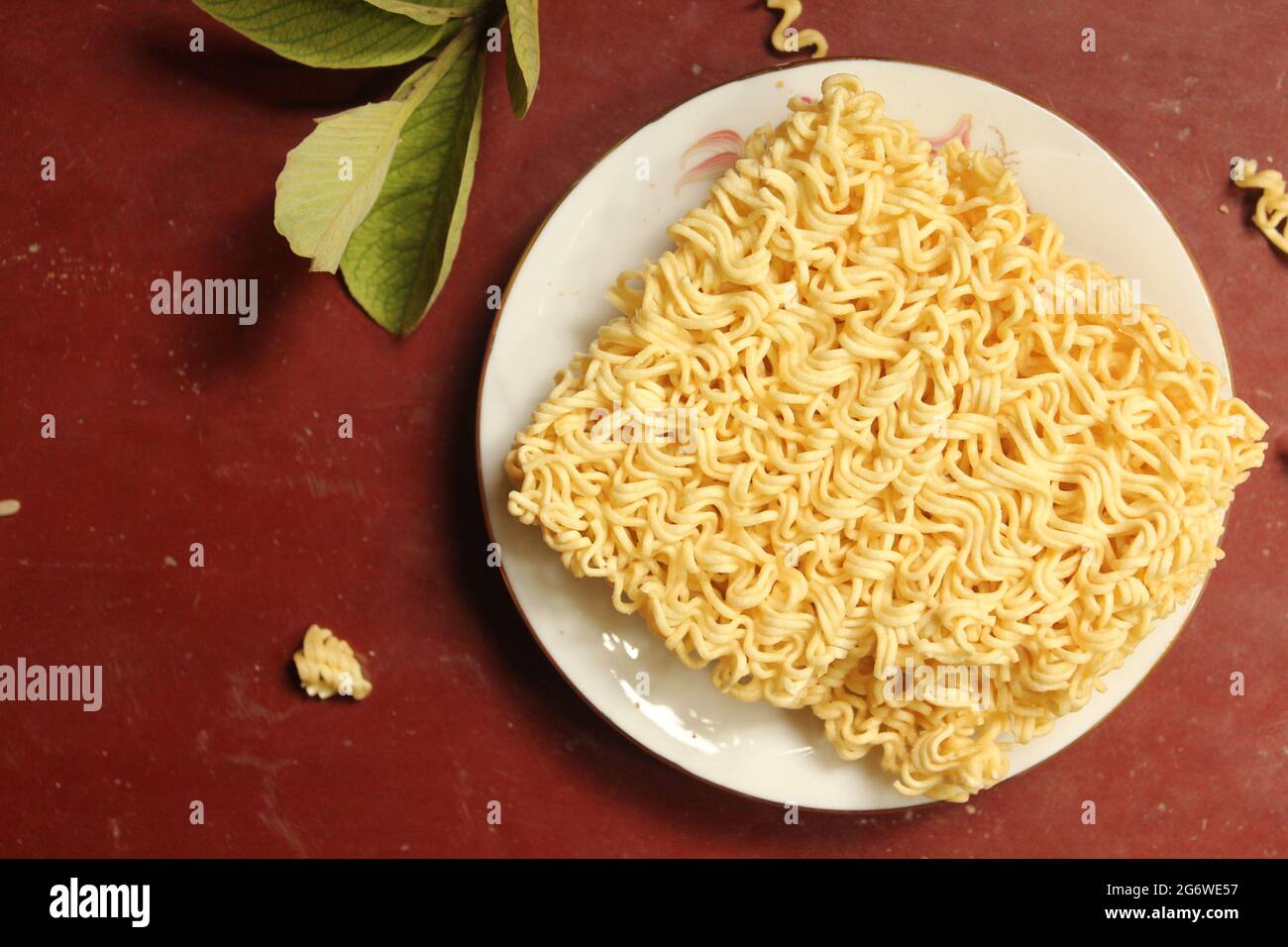 Uncooked noodles food on plate, top view Stock Photo