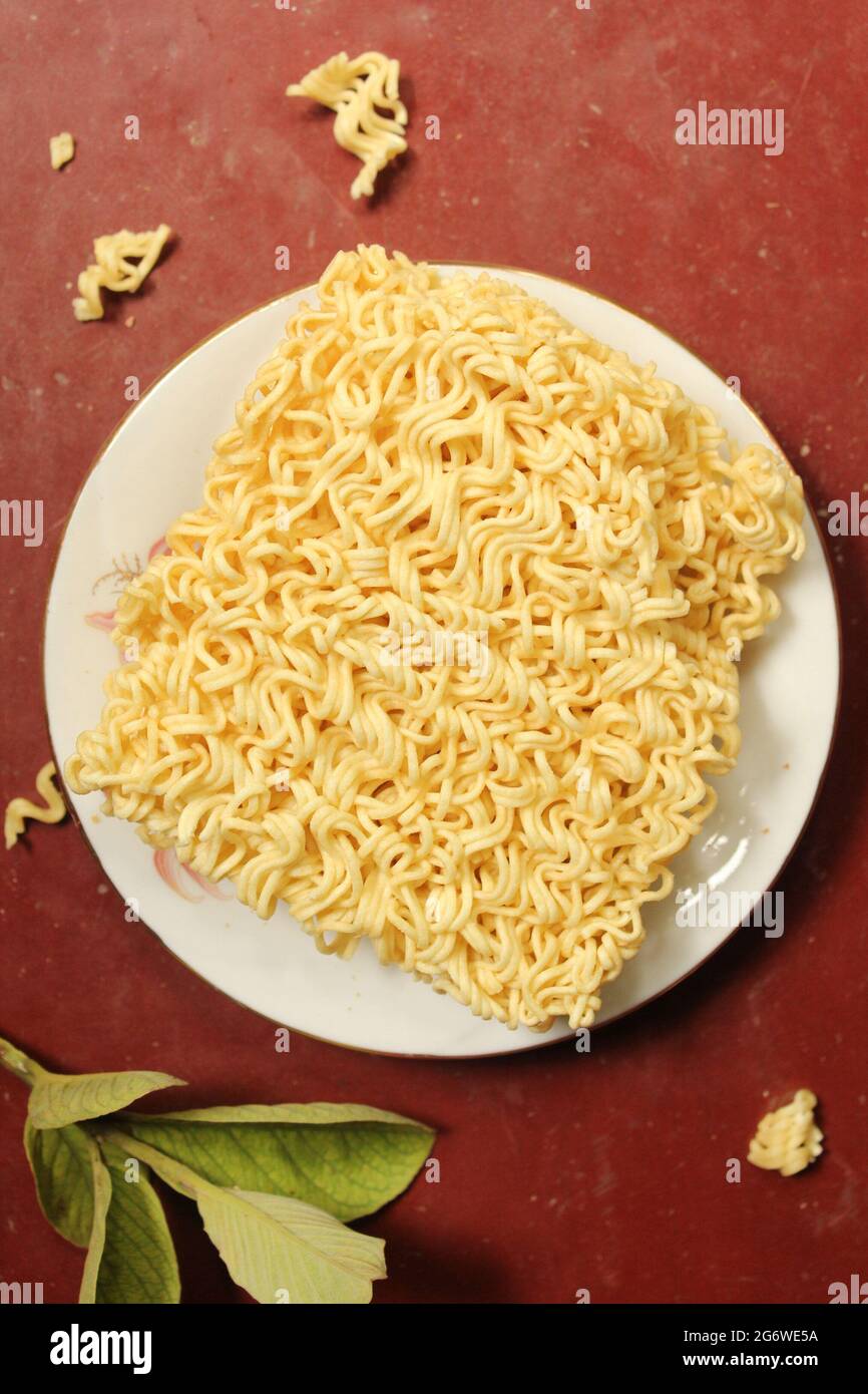 Uncooked noodles food on plate, top view Stock Photo