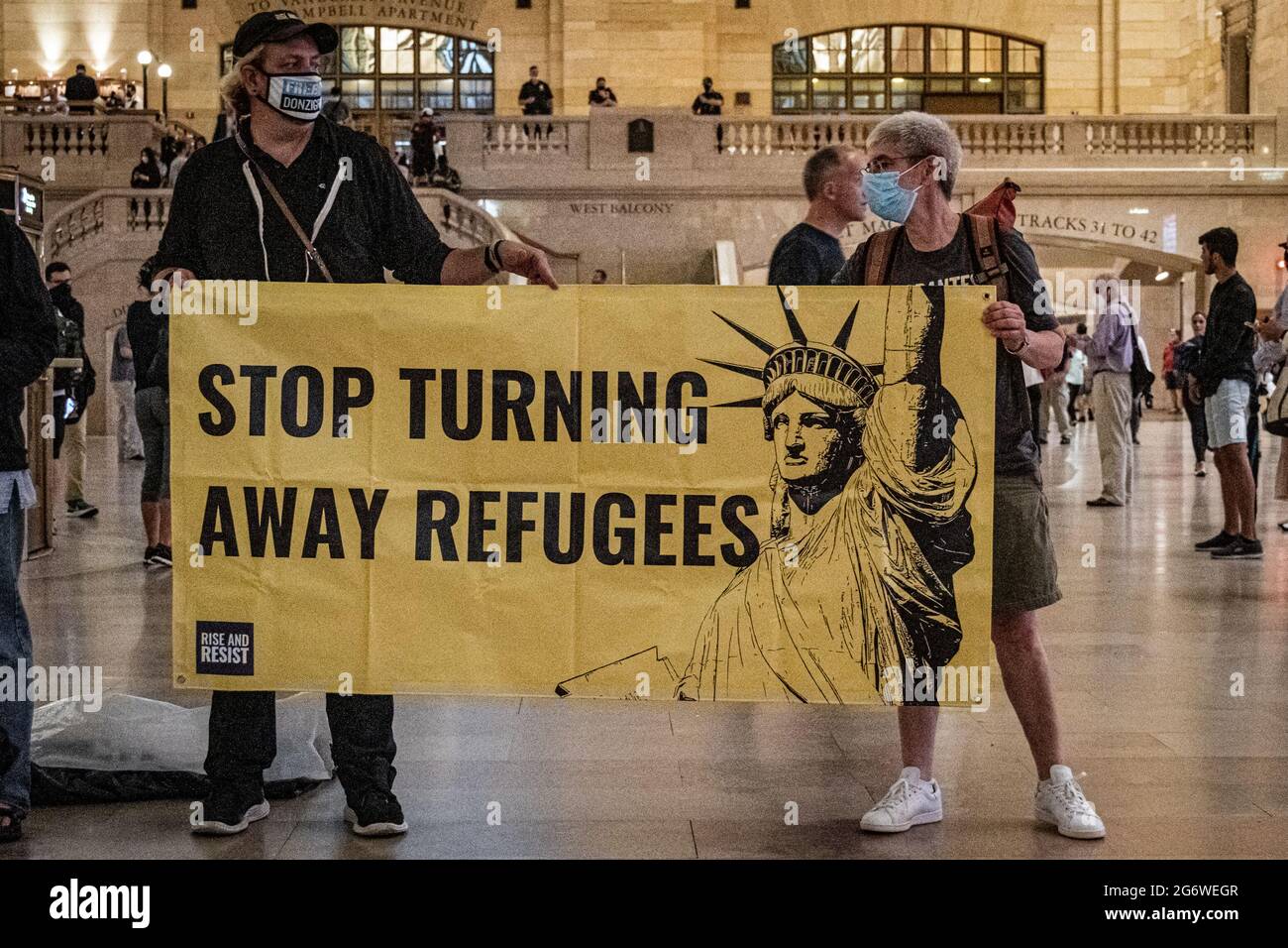 USA. 08th July, 2021. Members of the activist group Rise and Resist gathered on July 8, 2021 at the main hall in Grand Central Station for a protest demanding the Biden administration to permanently end using Title 42 exclusions to detain and deport refugees, to dismantle CBP (Customs and Border Patrol) and ICE (Immigration and Customs Enforcement), and to create a path to citizenship for all. (Photo by Erik McGregor/Sipa USA) Credit: Sipa USA/Alamy Live News Stock Photo