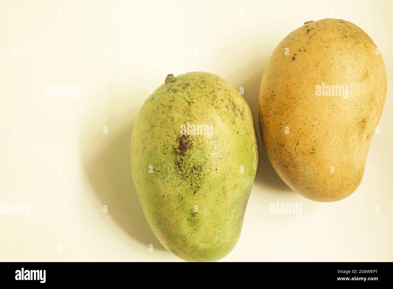 Yellow mangoes on isolated white, organic Stock Photo