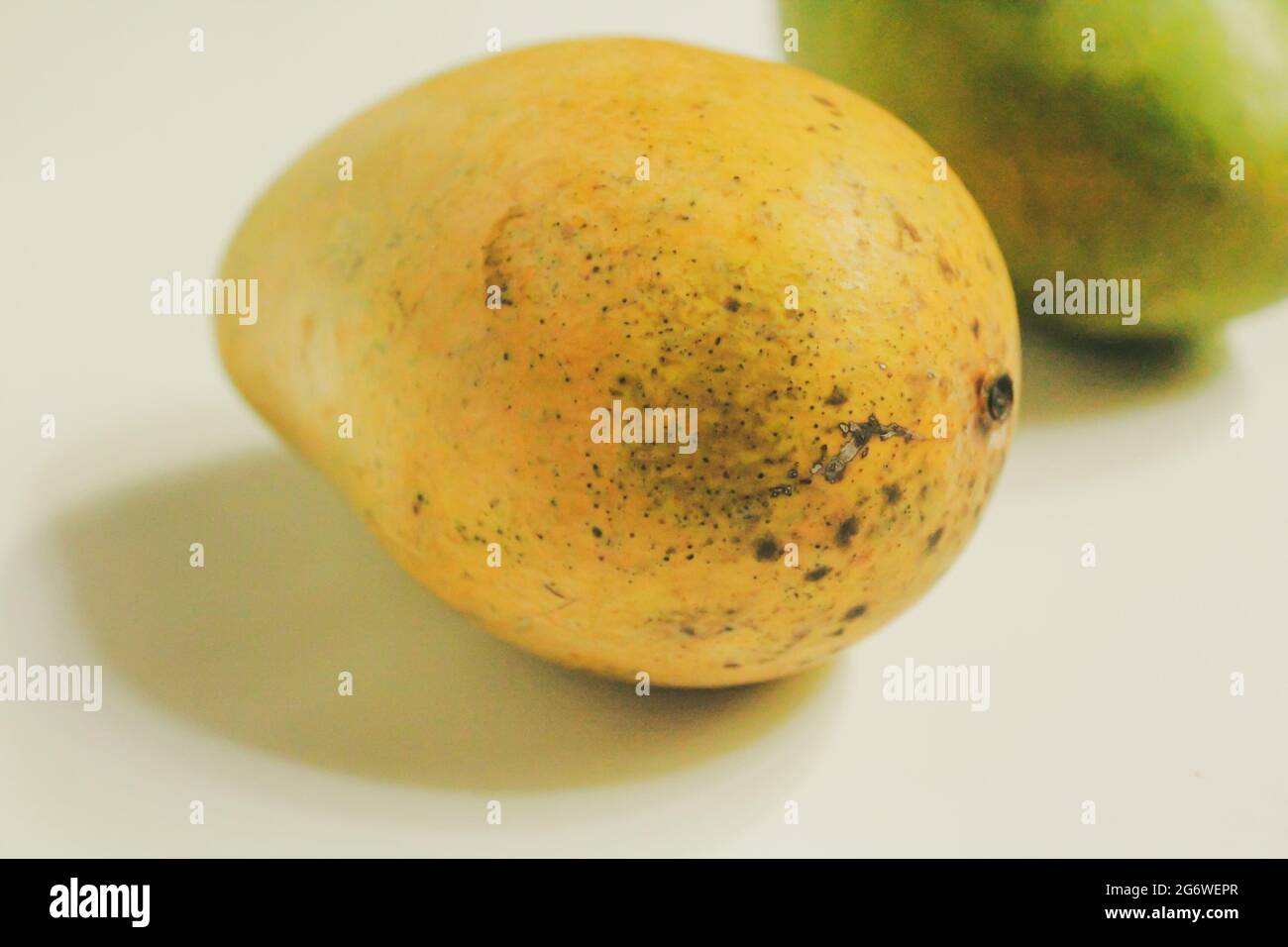 Yellow mangoes on isolated white, organic Stock Photo