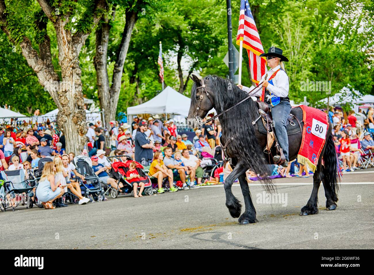 Prescott, Arizona, USA - July 3, 2021: Equestrian rider carrying an American flag while on horseback in the 4th of July parade Stock Photo
