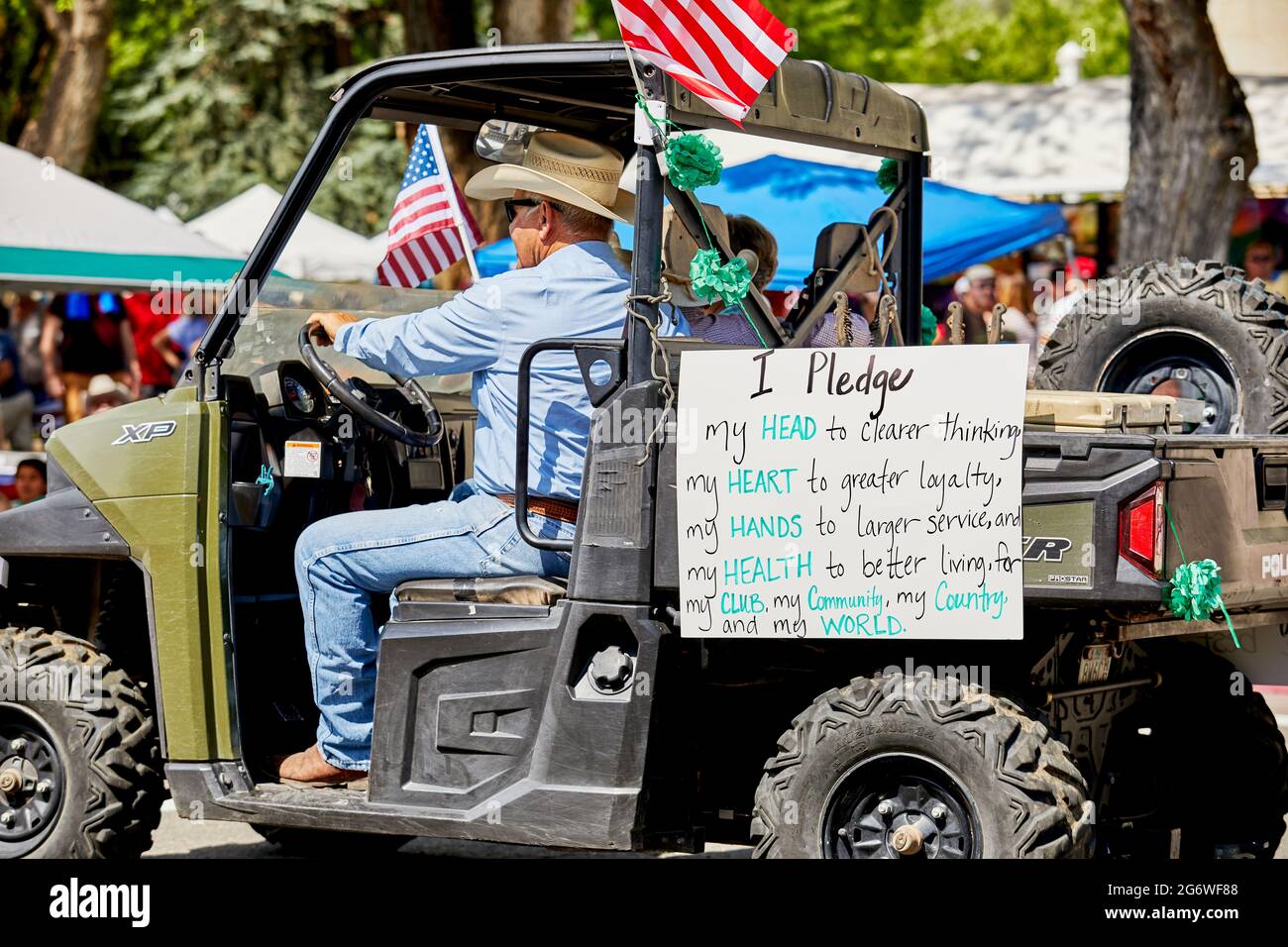 Prescott, Arizona, USA - July 3, 2021: Man driving an ATV with a pledge sign in the 4th of July parade Stock Photo