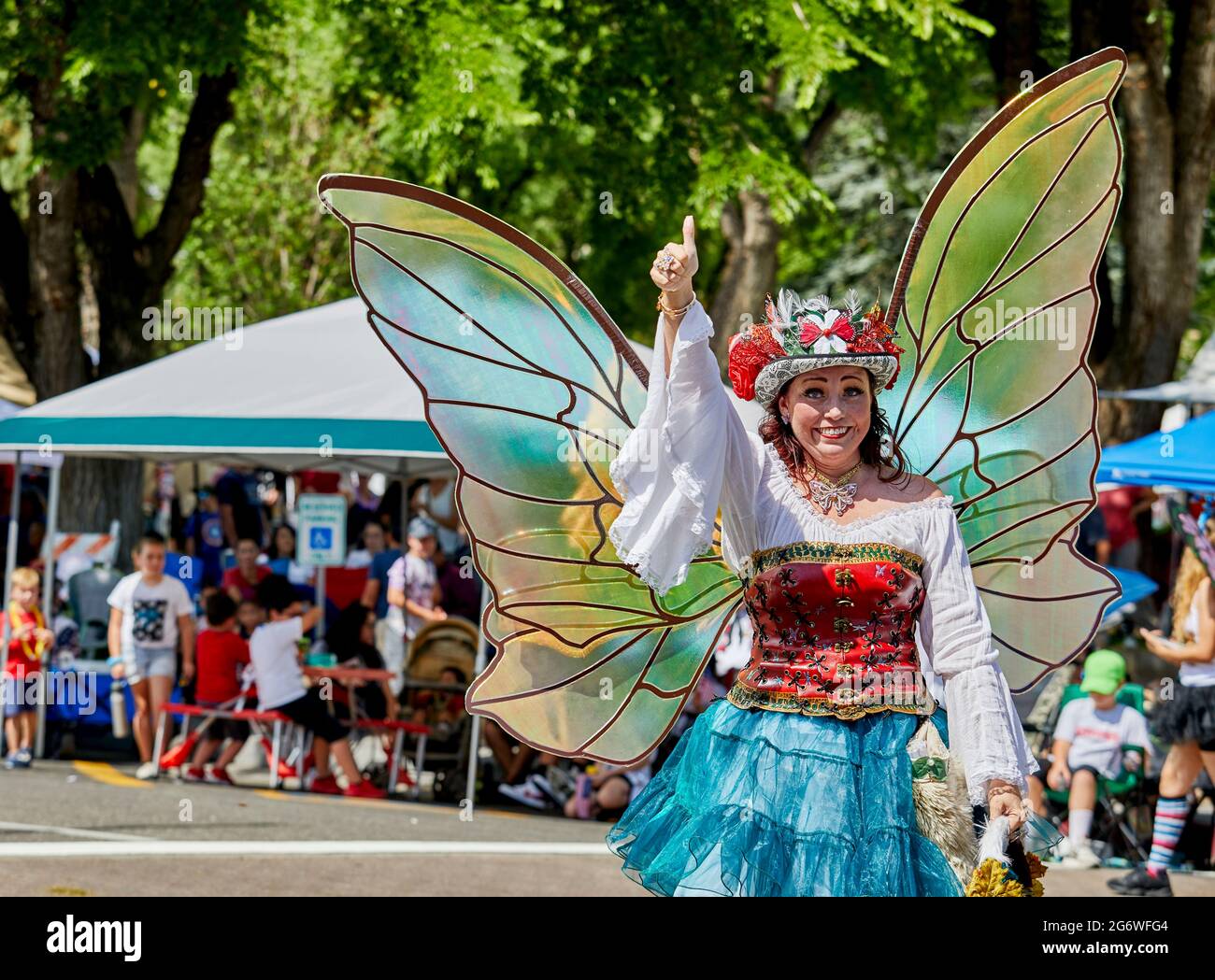 Prescott, Arizona, USA - July 3, 2021: Woman dressed in a butterfly costume with wings waving to the spectators in the 4th of July parade Stock Photo