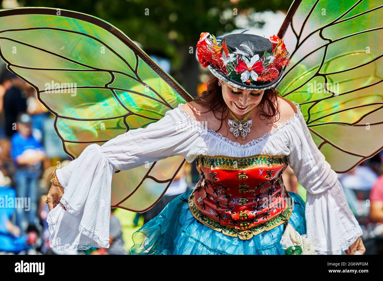 Prescott, Arizona, USA - July 3, 2021: Woman dressed in a butterfly costume with wings bowing to the spectators in the 4th of July parade Stock Photo