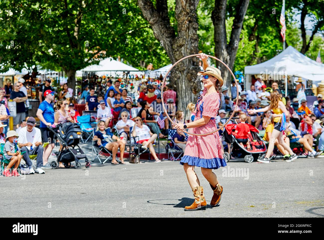 Prescott, Arizona, USA - July 3, 2021: Woman spinning the hula hoop while marching in the 4th of July parade Stock Photo