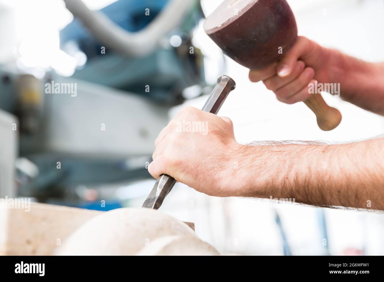 Stone carver working with hammer and chisel at marble column Stock ...