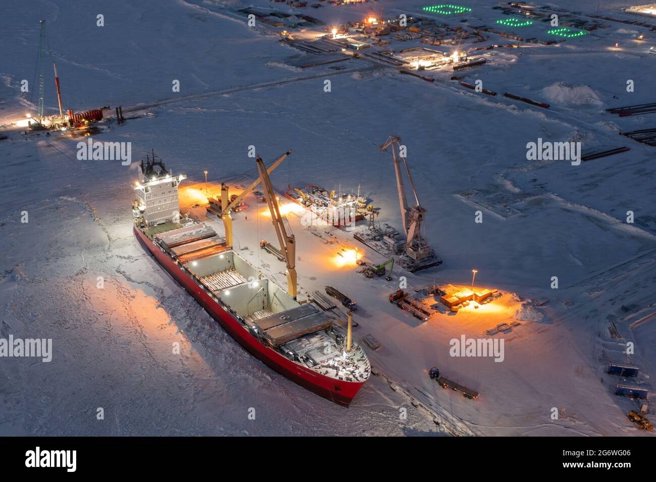 Sabetta, Tyumen region, Russia - December 07, 2020:The ship is engaged in cargo operations at the berth. The ship is frozen into the ice. Stock Photo