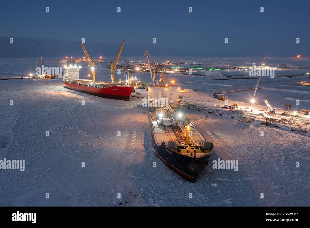 Sabetta, Tyumen region, Russia - December 07, 2020:The ship is engaged in cargo operations at the berth. The ship is frozen into the ice. Stock Photo