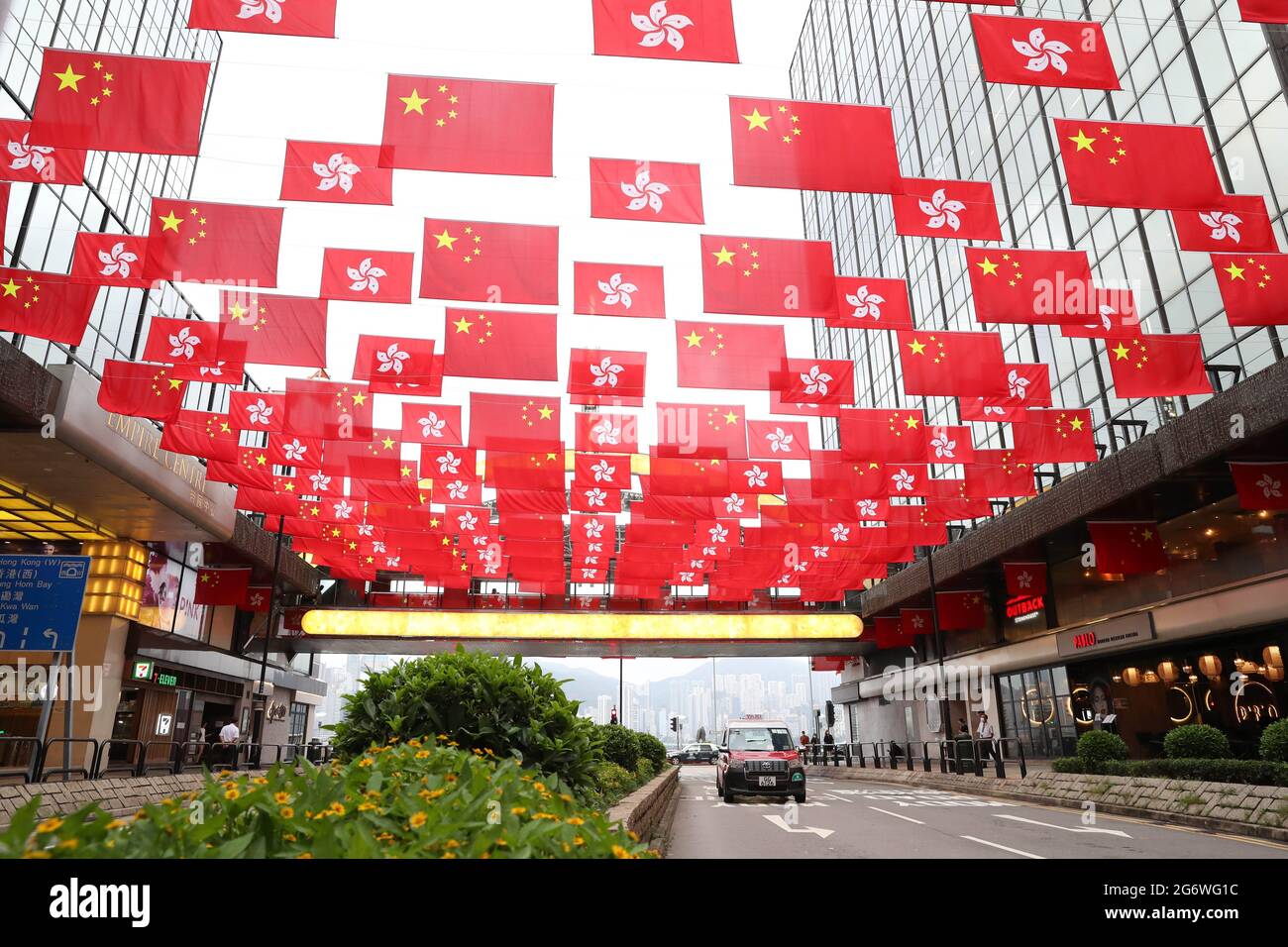 Hong Kong. 29th June, 2021. Photo taken on June 29, 2021 shows China's national flags and flags of the Hong Kong Special Administrative Region (HKSAR) on a street in south China's Hong Kong. TO GO WITH 'Xinhua Commentary: National security law in Hong Kong brooks no slander' Credit: Li Gang/Xinhua/Alamy Live News Stock Photo
