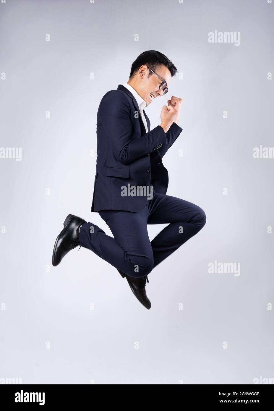 Portrait of business man wearing suit, isolated on white background ...