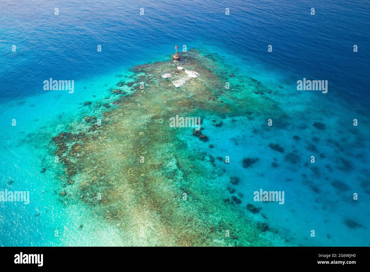 Shallow waters of Persian Gulf, Saudi Arabia. Red warning beacon with ...