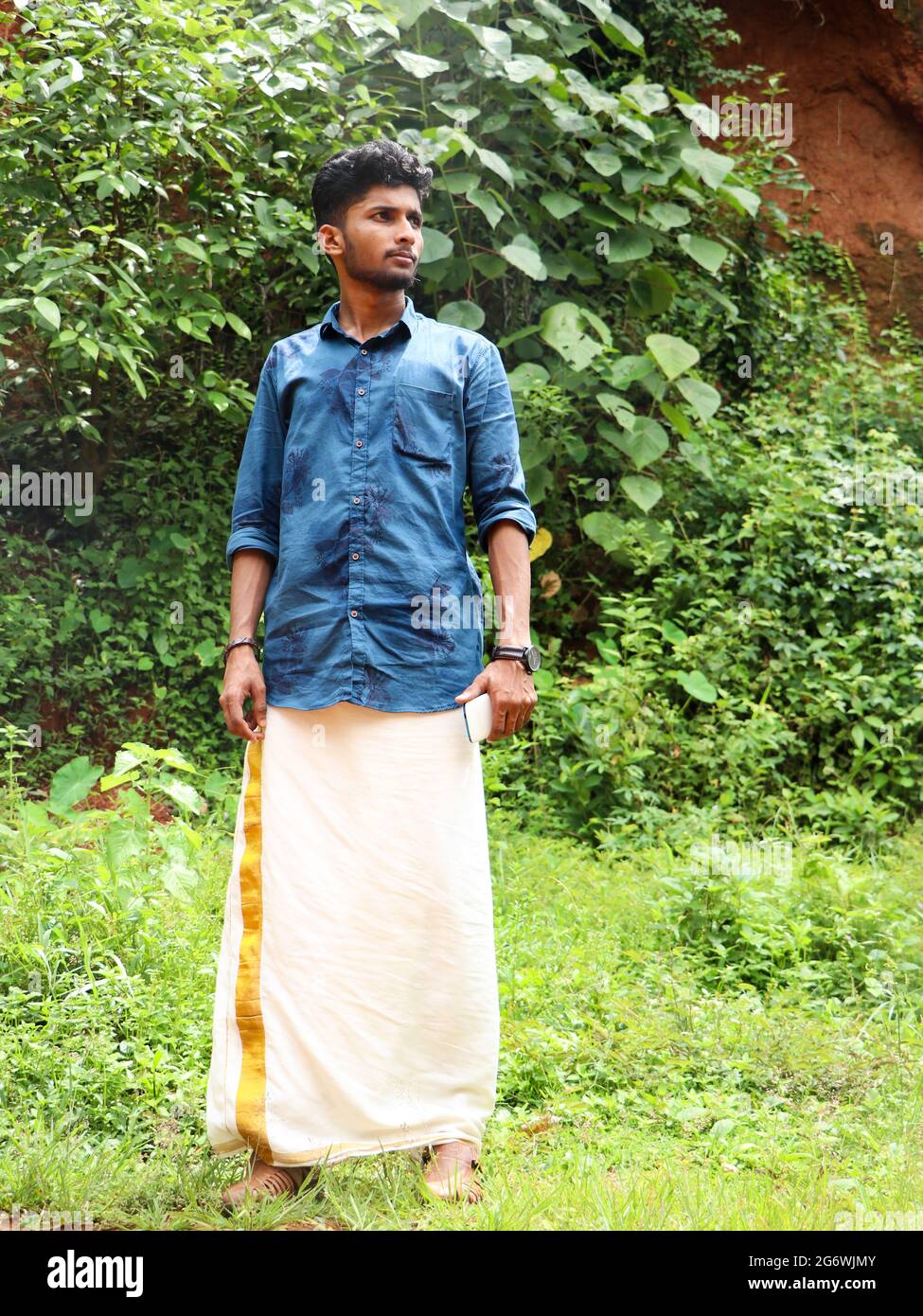 male model in traditional indian clothing standing in the garden during a  sunny onam festival Stock Photo - Alamy