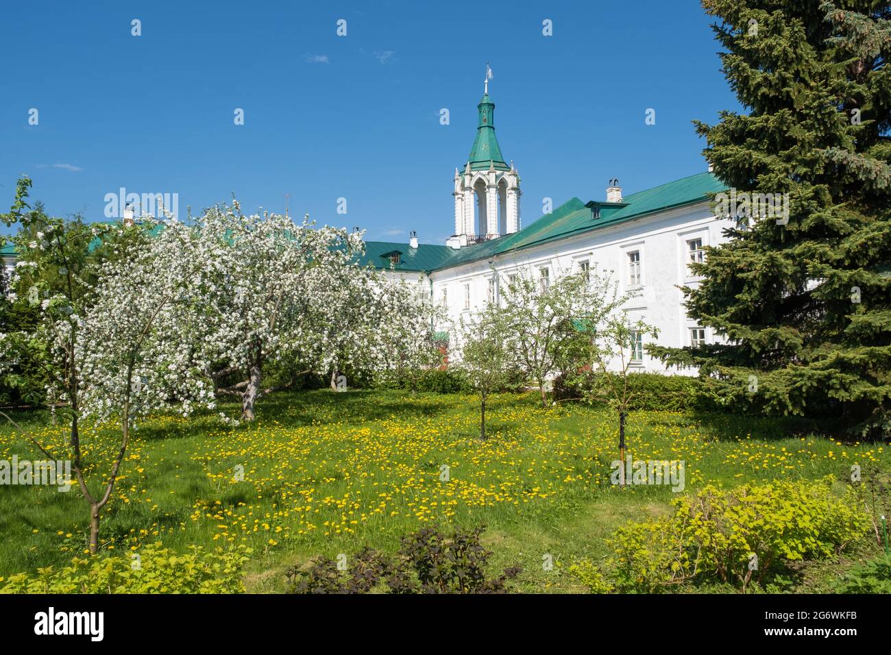 Blooming trees in the Spaso-Yakovlevsky Monastery on a sunny day in the city of Rostov, Yaroslavl region, Russia. Stock Photo