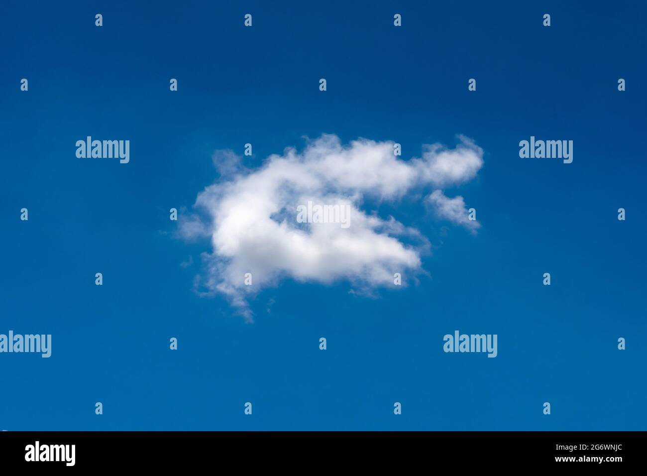 Beautiful cloudscape of nature single white cloud on blue sky background in daytime Stock Photo