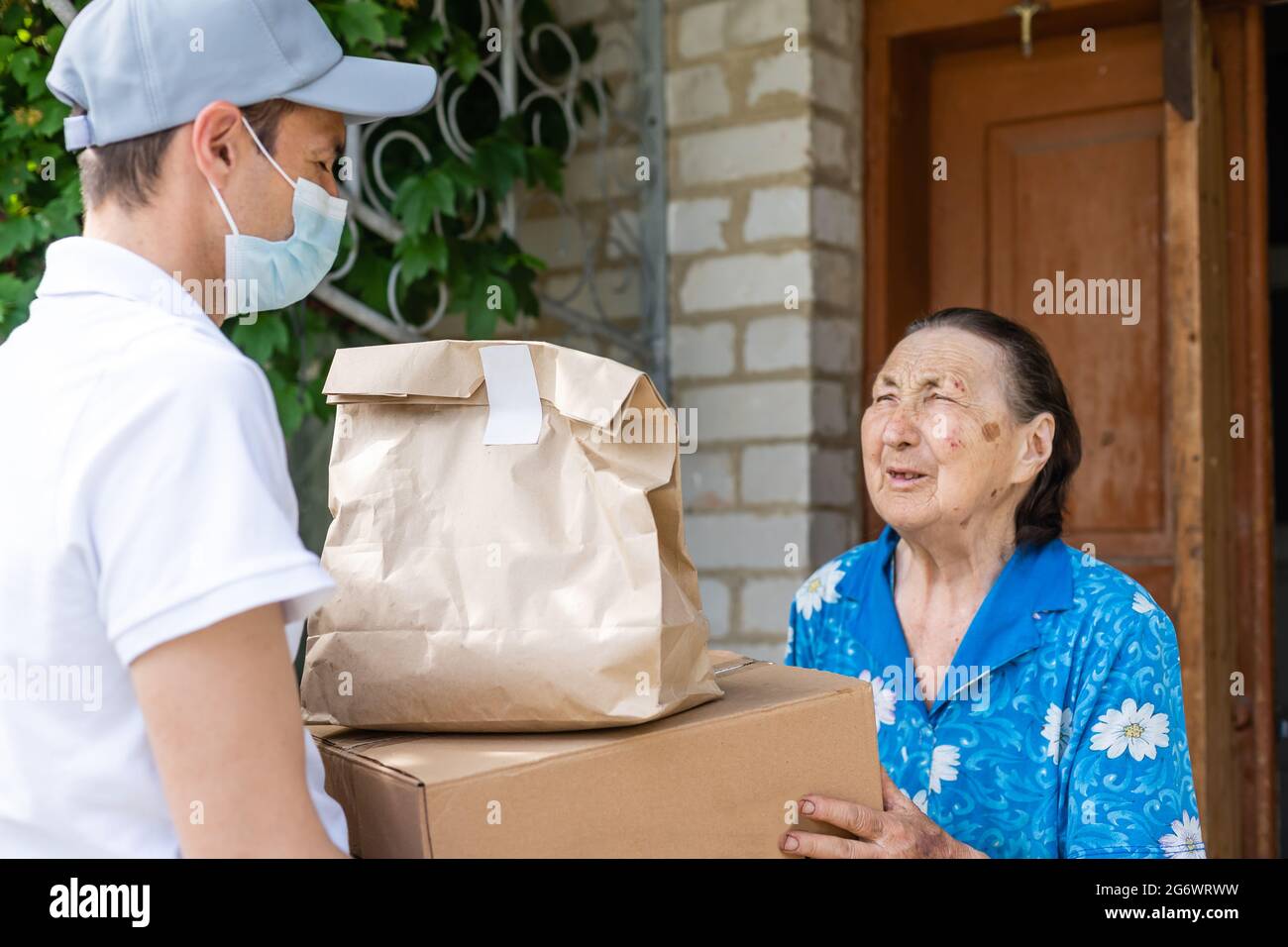 food delivery man for an elderly woman Stock Photo Alamy