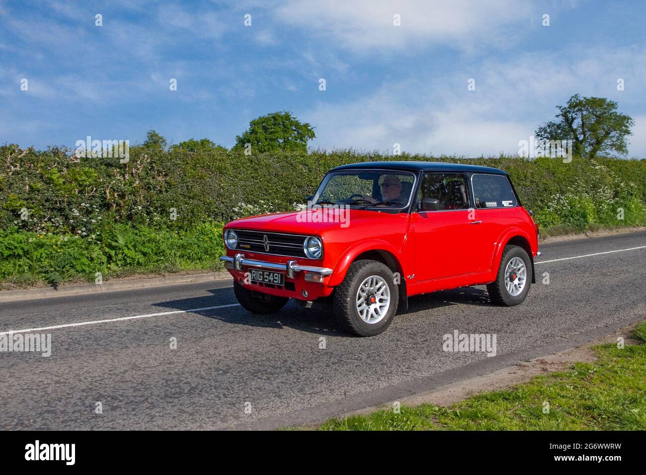 1972 red customised 2dr Mini 1590cc petrol en-route to Capesthorne Hall classic May car show, Cheshire, UK Stock Photo