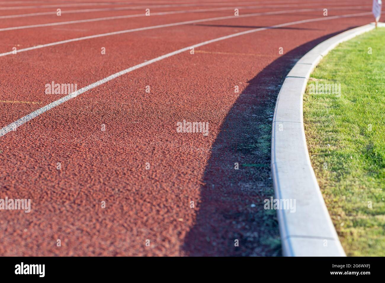 Part Red plastic track in the outdoor track and field stadium.Closeup. Stock Photo