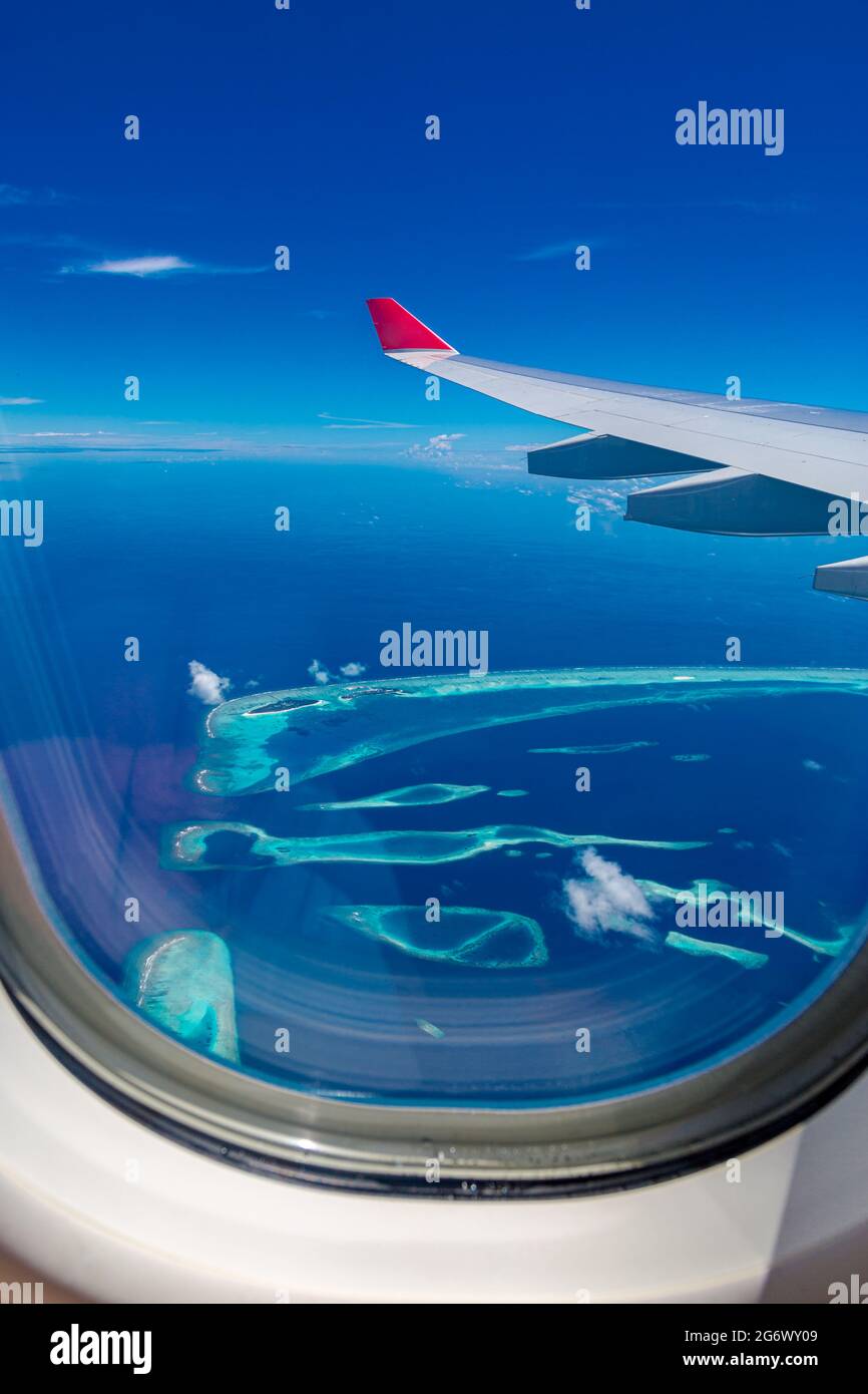 Maldives islands top view from airplane window. Idyllic exotic travel Stock Photo
