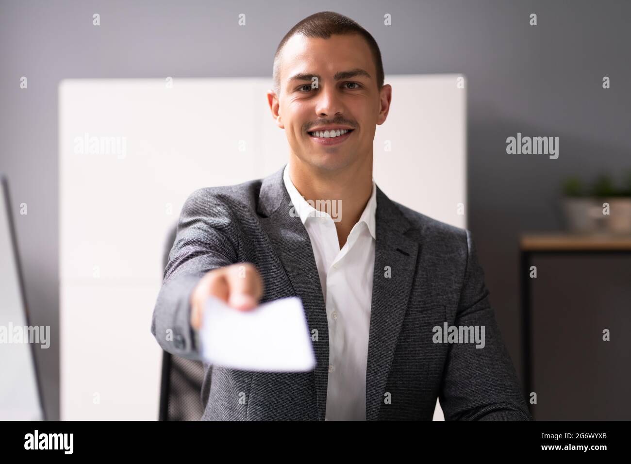 Black Business Man Holding Pay Check Or Paycheck Stock Photo