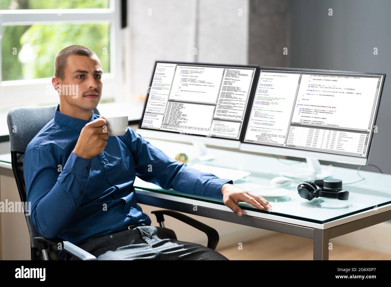 Computer Programmer Writing Program Code On Computer In Office Stock Photo