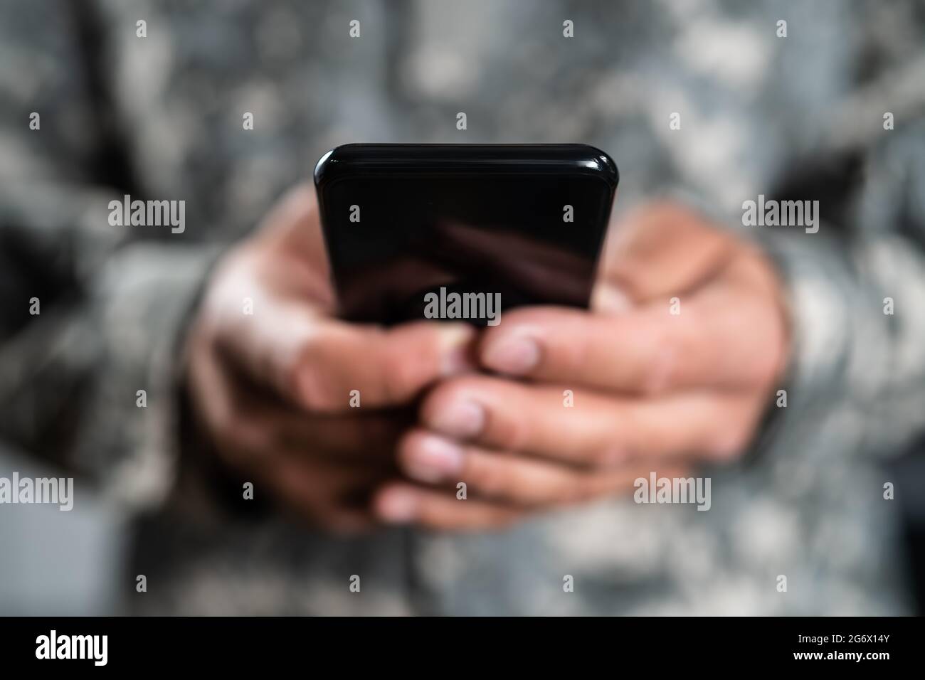 US Military Soldier Smart Phone Espionage. Cyber War Stock Photo