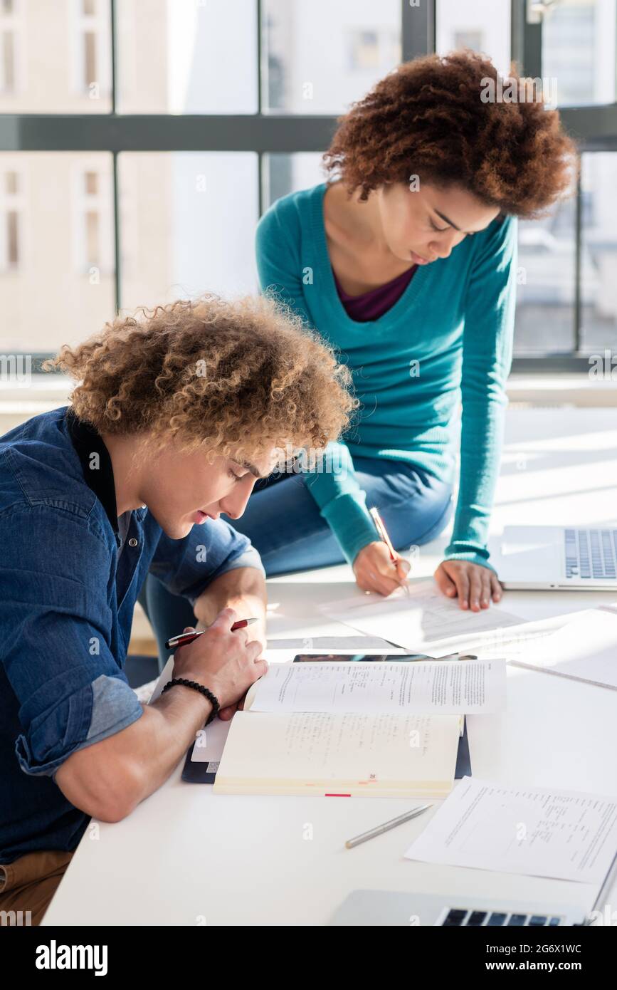 Young creative student writing observations and ideas for an assignment