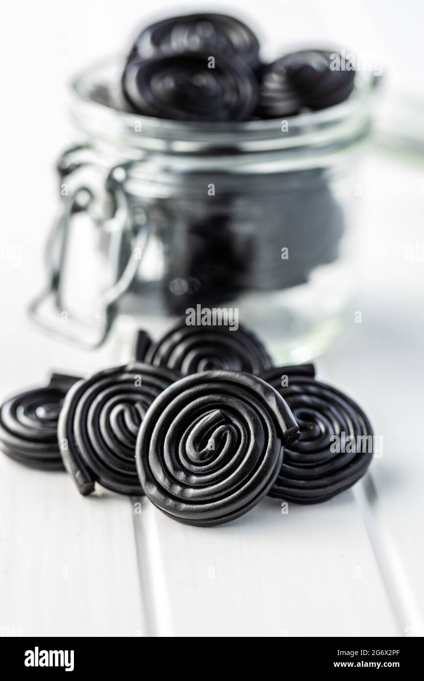 Spiral from liquorice candy on white table. Stock Photo