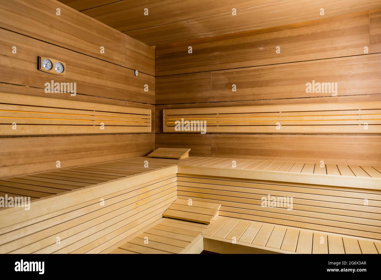 Interior of an empty dry sauna with brown wooden walls and benches in a modern hotel or in a spa and wellness center Stock Photo