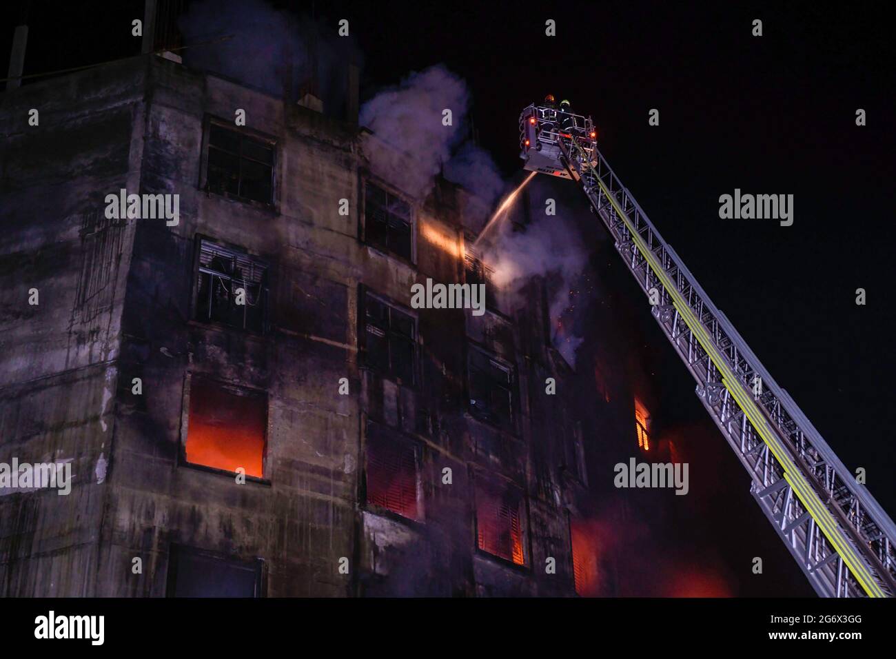 Firefighters try to extinguish fire inside the building after a fire ...
