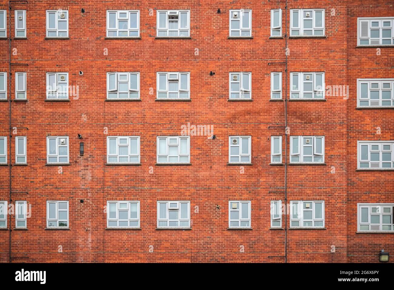 Facade of a red brick mansion block around Hackney in London Stock