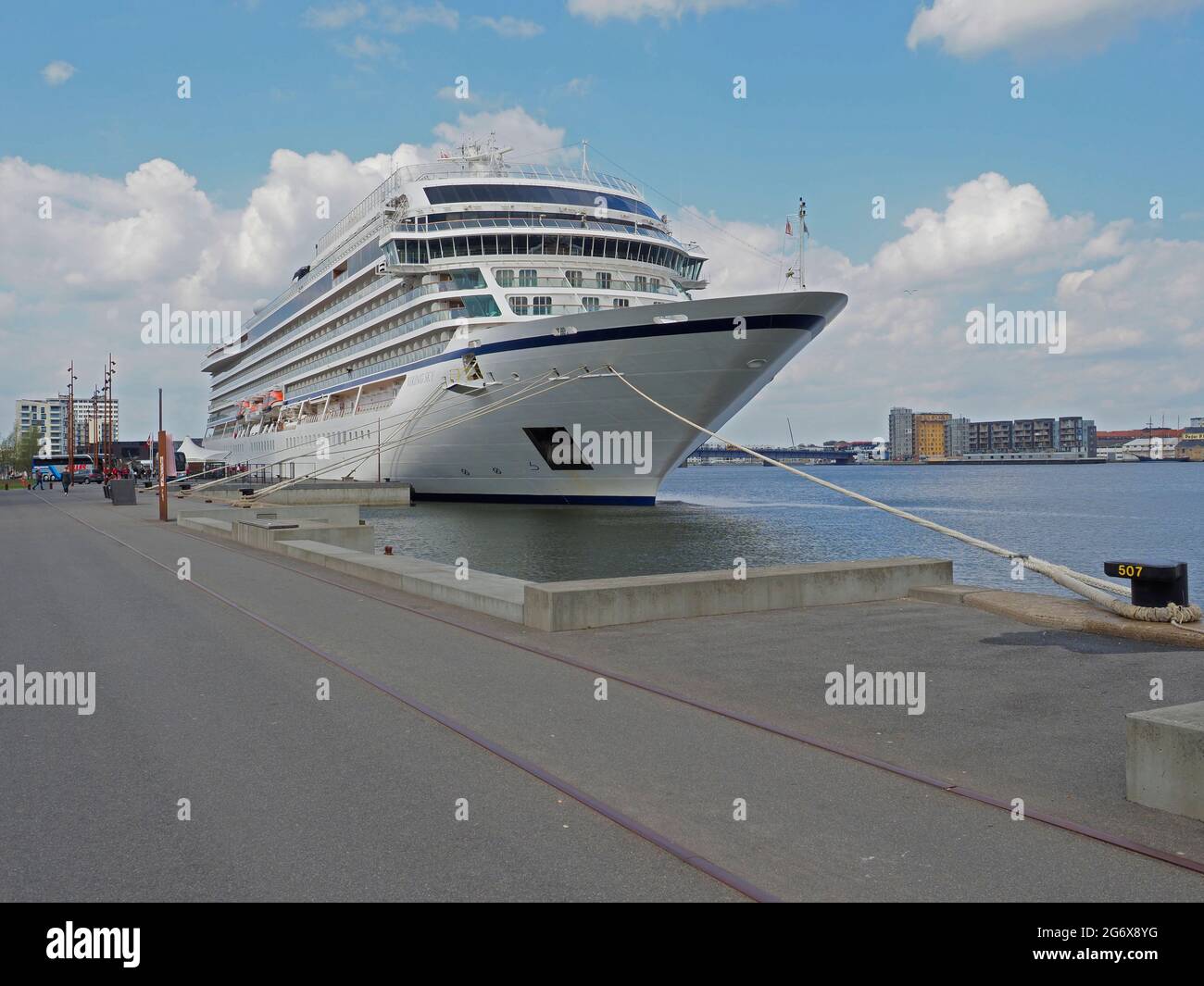 Viking Cruise ship moored in Aalborg Jutland Denmark Europe hiding behind modern harbour building Stock Photo