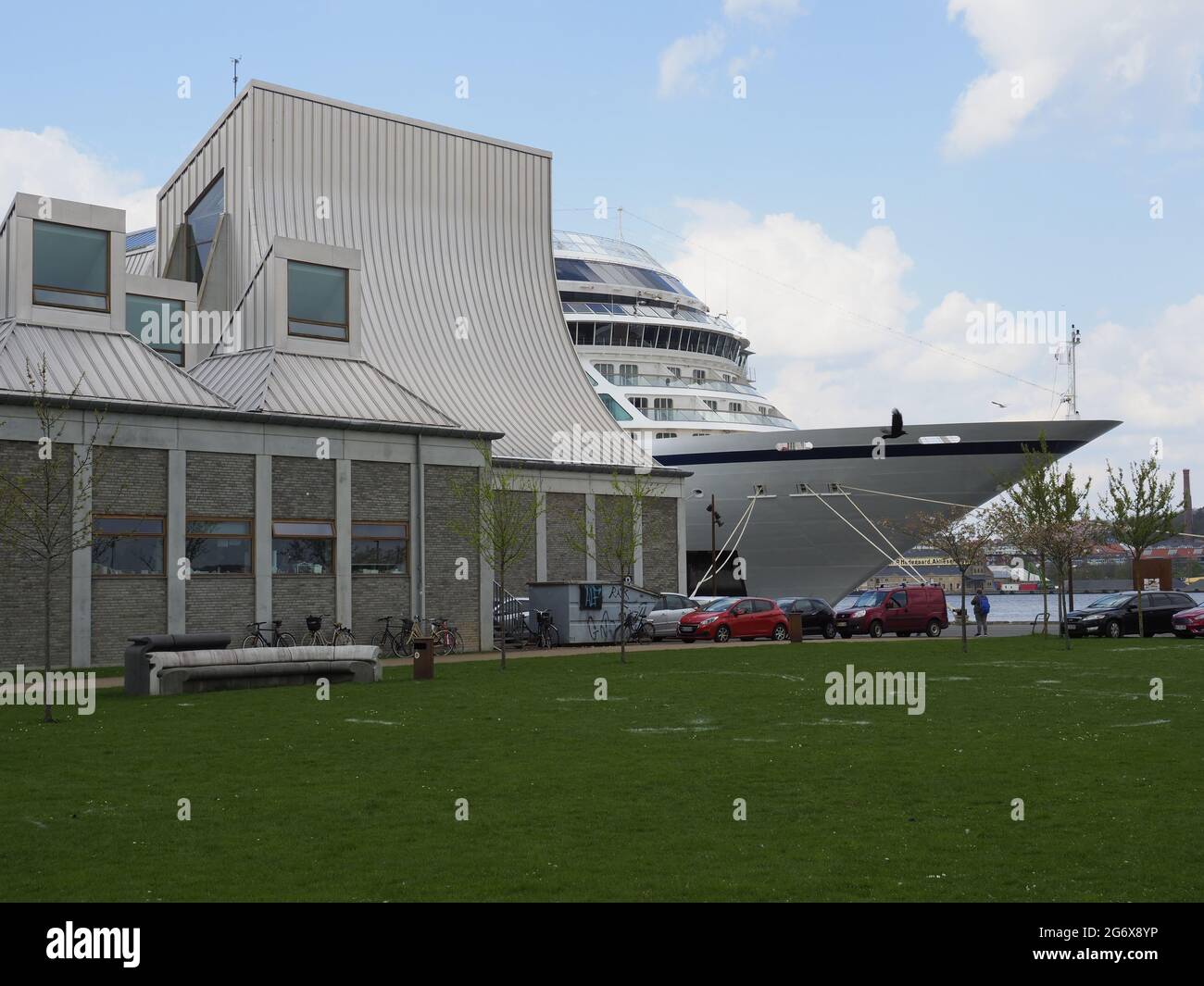 Viking Cruise ship moored in Aalborg Jutland Denmark Europe hiding behind modern harbour building Stock Photo