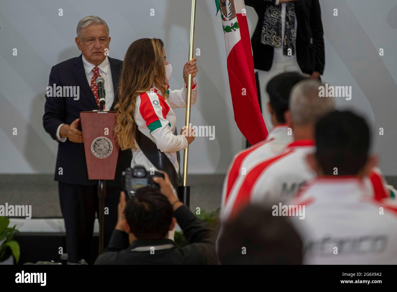 MEXICO CITY, MEXICO JULY 5: Golfer Gabriela Lopez holds the Mexican flag white the Mexico’s President, Andres Manuel Lopez Obrador  speaks  during the  Ceremony of Flagging of the athletes who will represent Mexico towards the XXXII Olympic Games, Tokyo 2021 at National Center for the Development of Sports Talents and High Performance (CNAR) on July 5, 2021 in Mexico City, Mexico. Credit: Ricardo Flores/Eyepix Group/The Photo Access Stock Photo