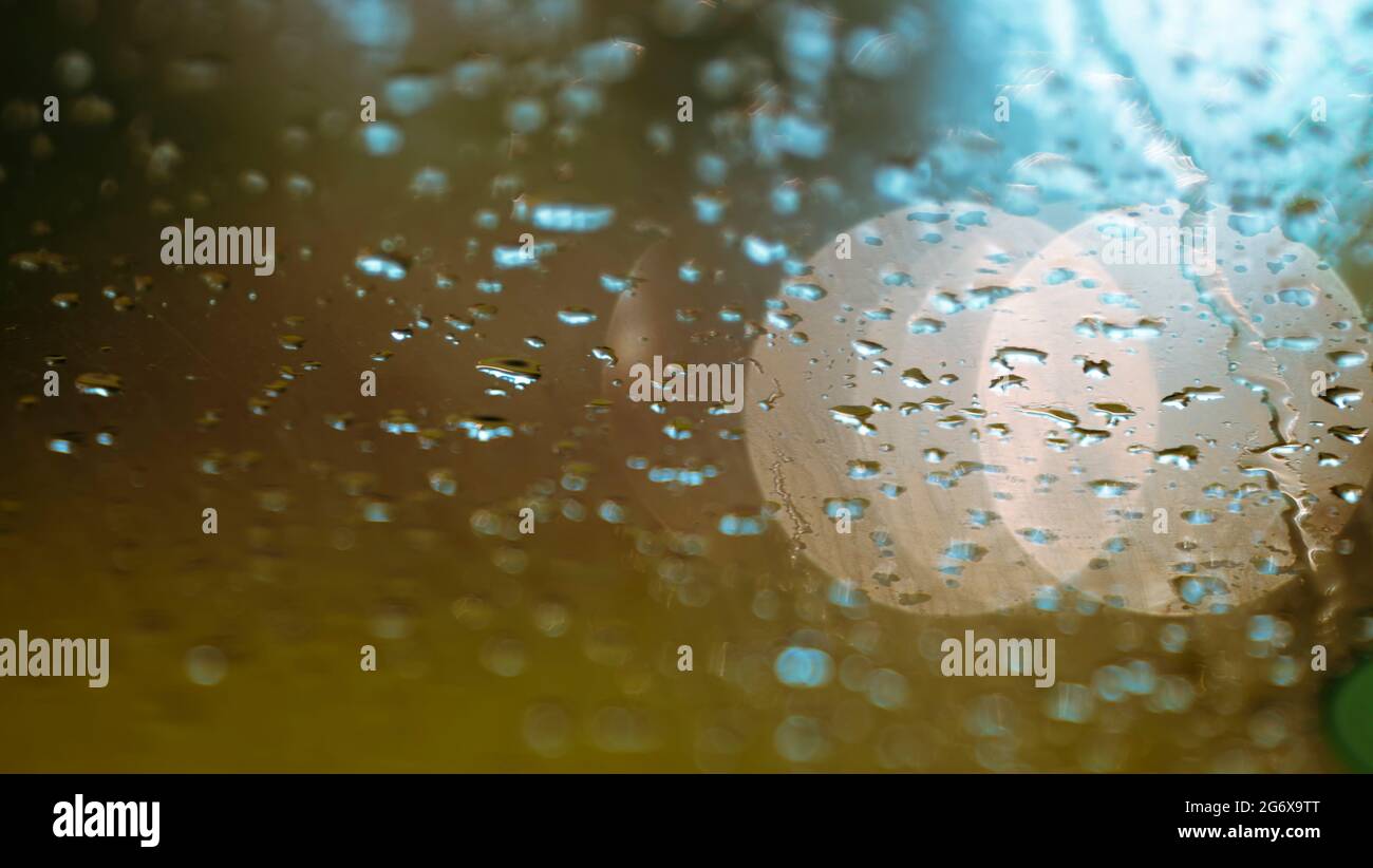 Raindrops on the windshield and car lights The scenery is charming and romantic Ahmed Arnaoty Stock Photo