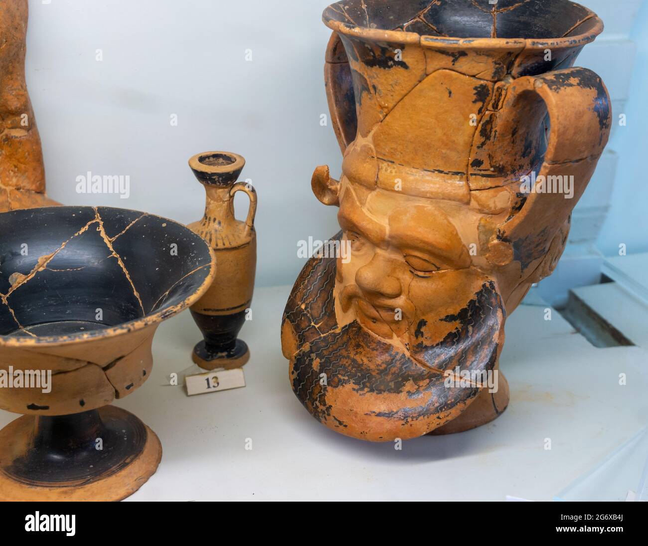 SANTA MARINELLA, ROME, ITALY - March 25, 2020: Collection of ancient Etruscan vases with a cup for wine with human face (6th century BC) Stock Photo