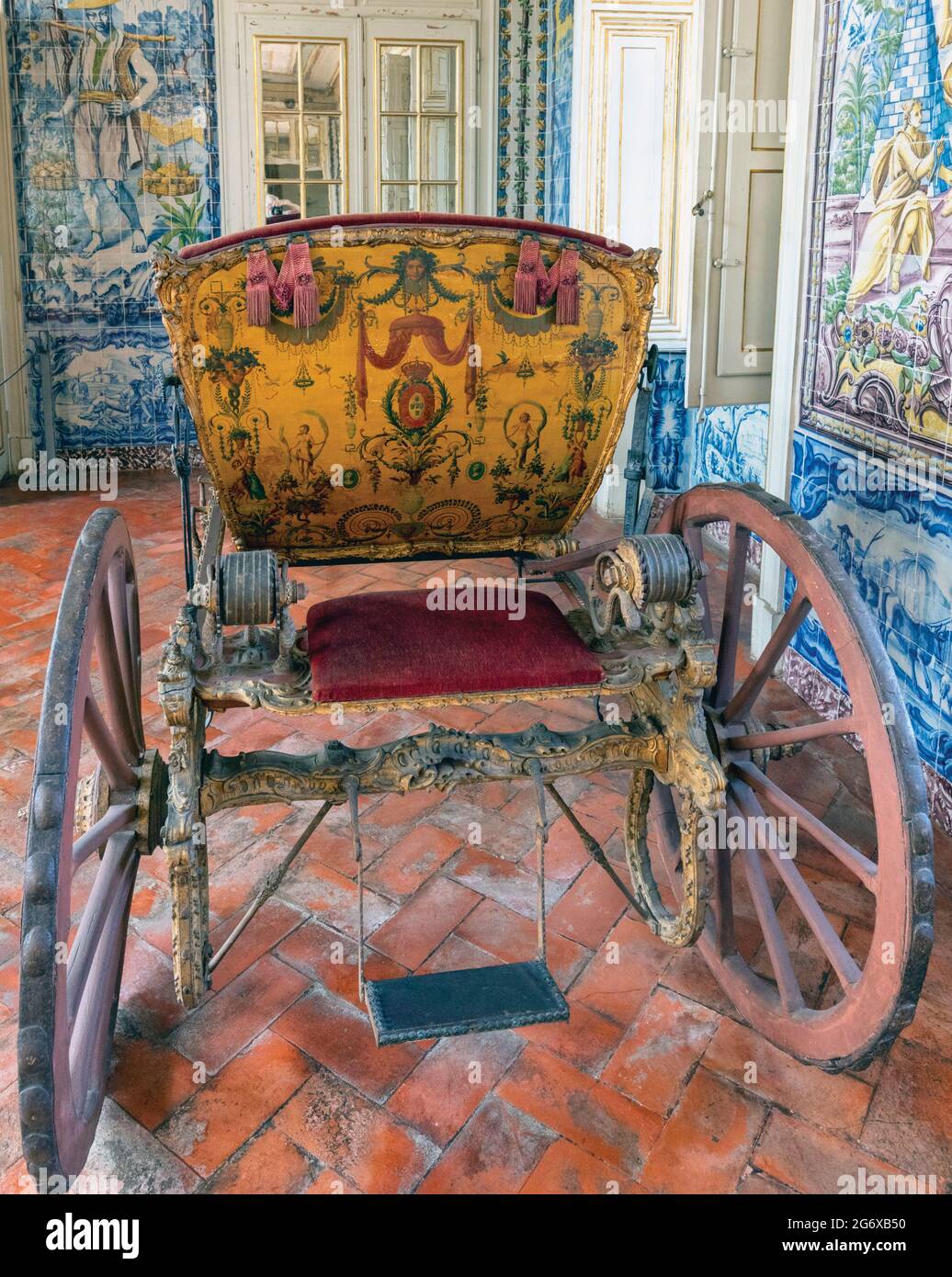 Queluz Palace, Sintra Municipality, Portugal.    Richly decorated horse-drawn carriage in the Corredor dos Azulejos, or Tiled Hallway, also known as t Stock Photo