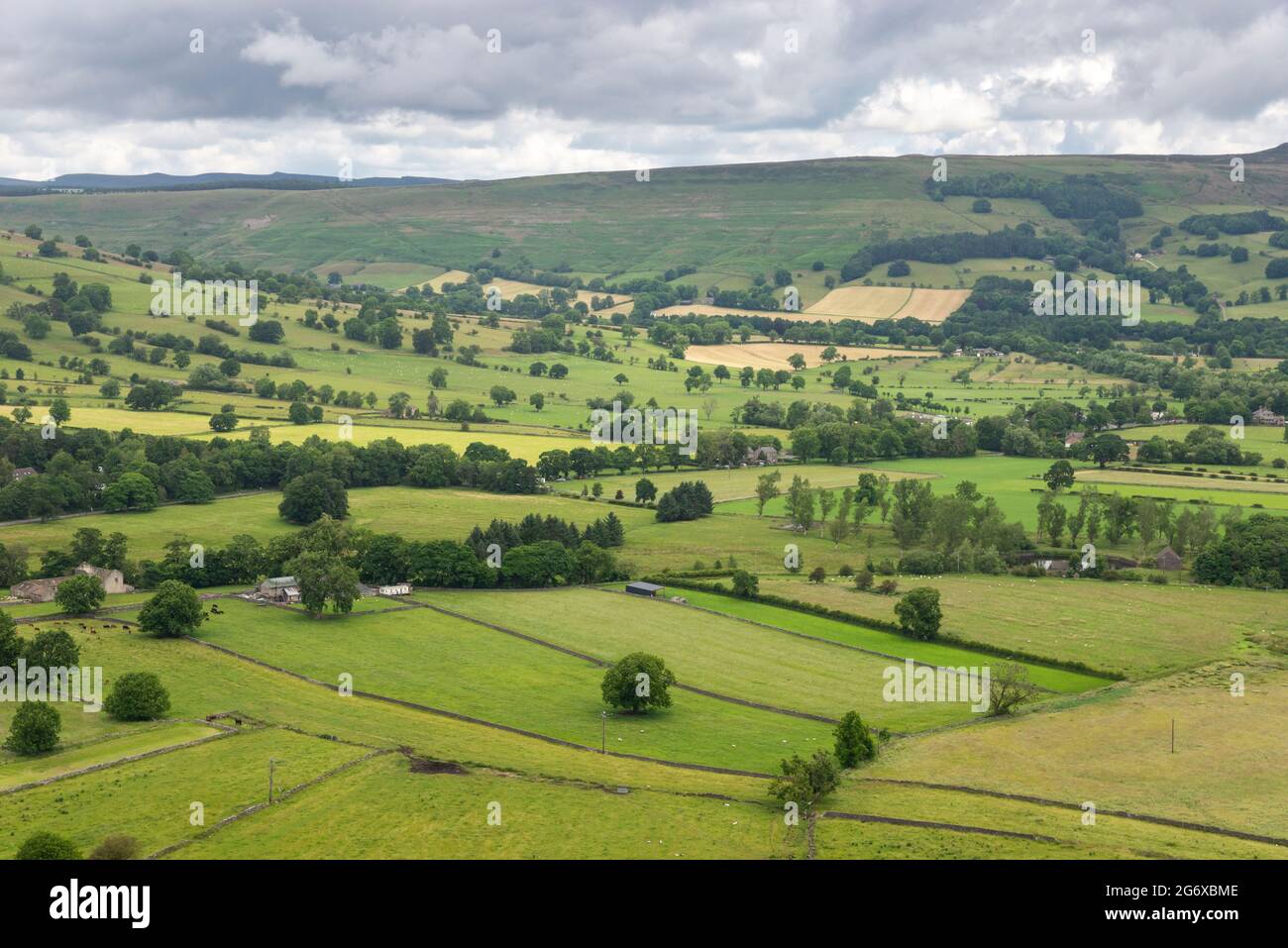 Patchwork of green fields in the Hope Valley, Derbyshire, England. Lines of hedges and trees separating the fields. Stock Photo