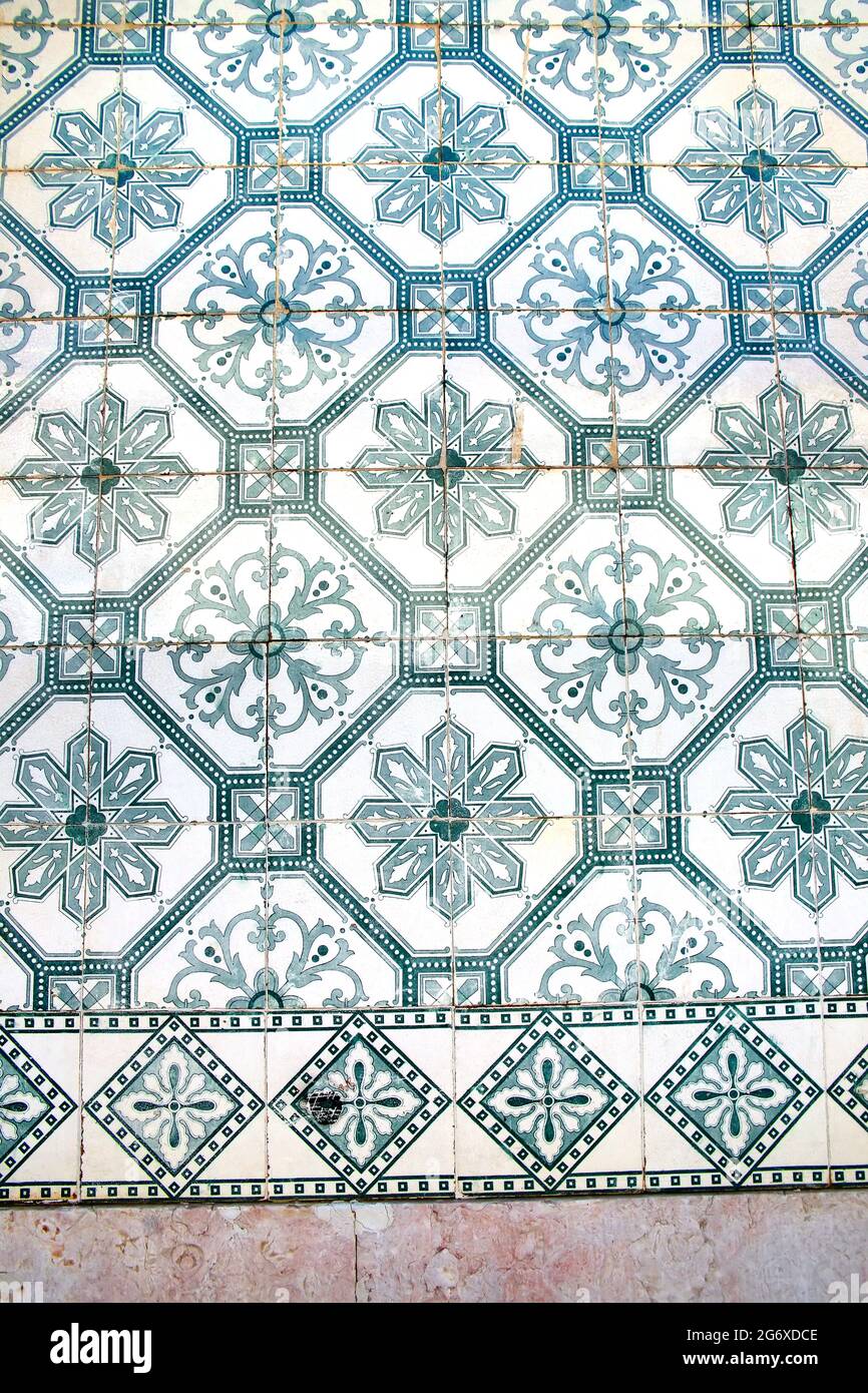 Glazed blue ceramic tiles or azulejos  which cover many buildings in Lisbon, Portugal. These Portuguese tiles have many different geometric designs. Stock Photo