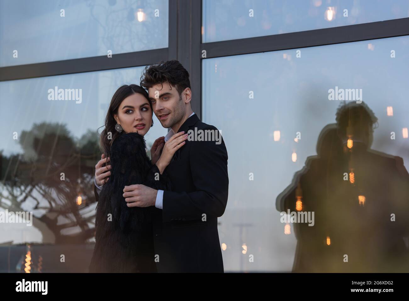 woman in faux fur jacket hugging elegant man in suit outdoors Stock ...