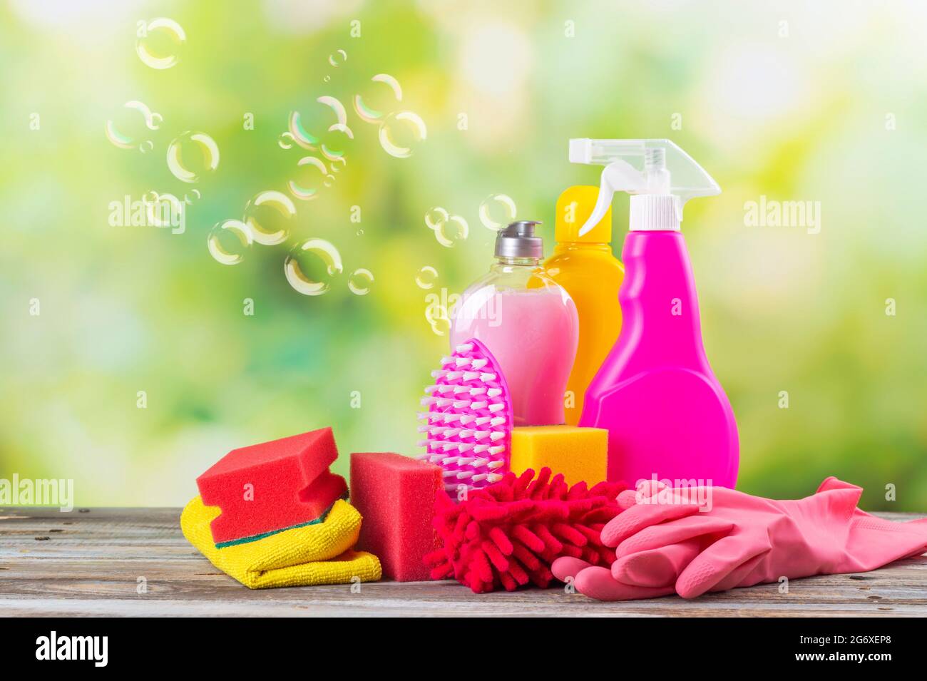 Spring cleaning office or house concept. Different cleaning supplies over  blurred spring background among floating soap bubbles. Copy space Stock  Photo - Alamy