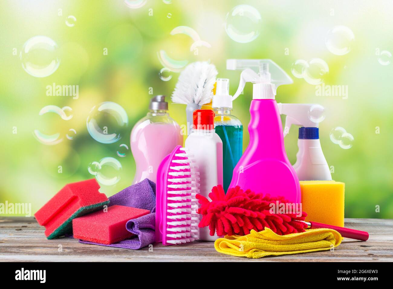 Spring cleaning office or house concept. Different cleaning supplies over  blurred spring background among floating soap bubbles. Copy space Stock  Photo - Alamy