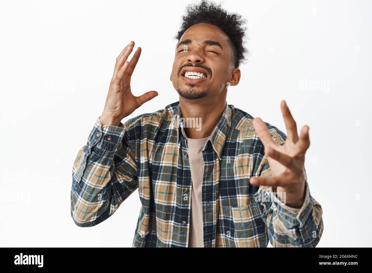 Image of happy and relieved african american man rejoicing, feeling