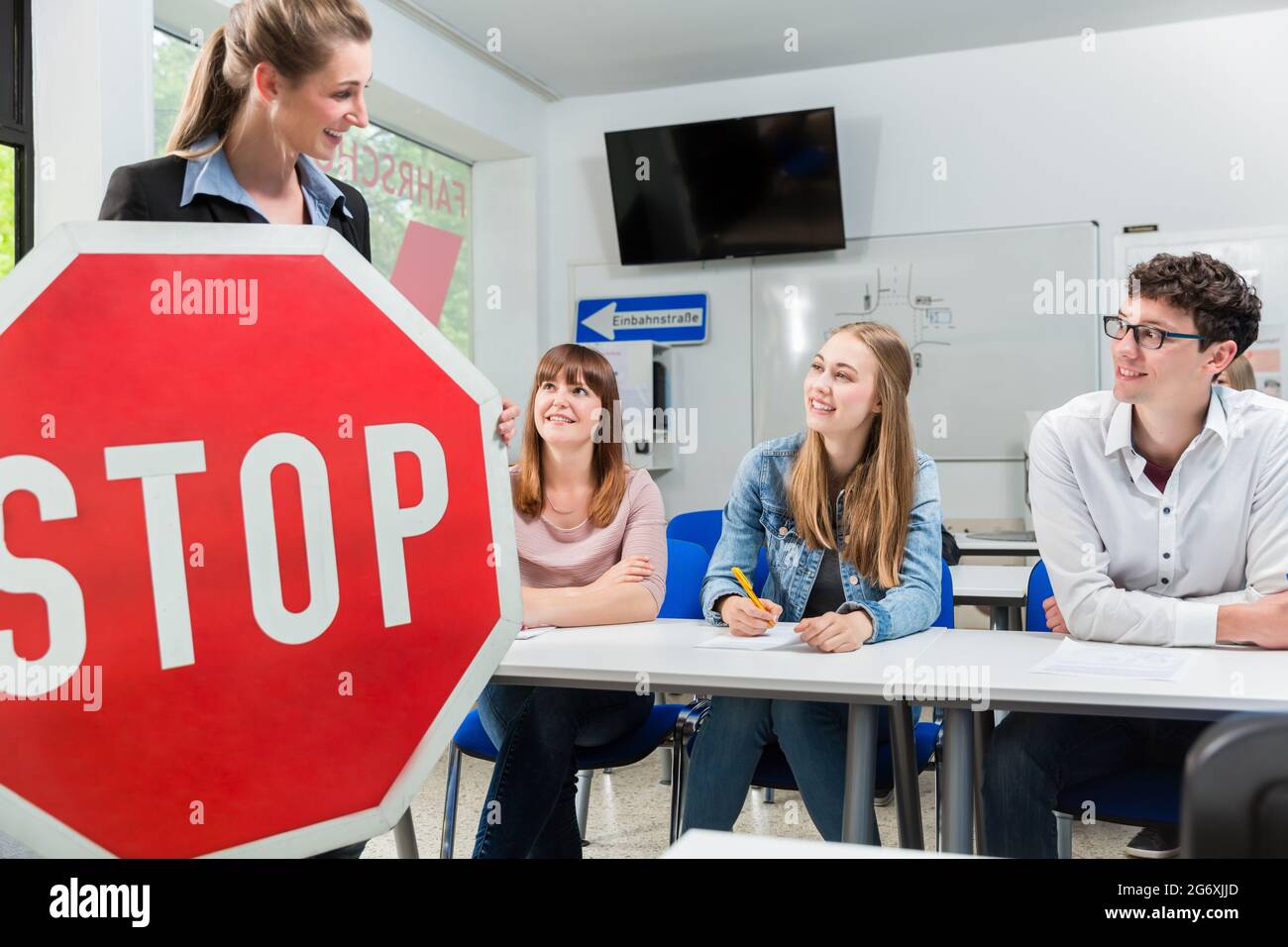 Driving instructor holding theoretical part of driving lessons with ...